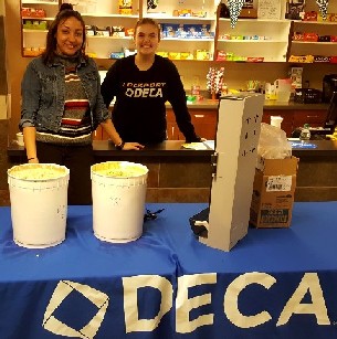 Students handing out samples at a DECA table