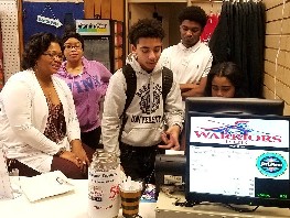 Students at a School POS station and its marketing monitor