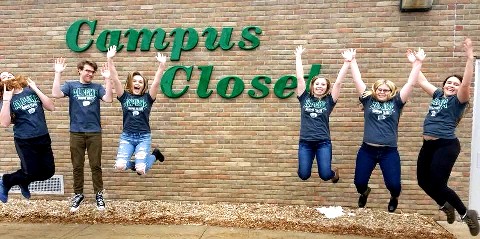 Students jumping in front of the Campus Closet